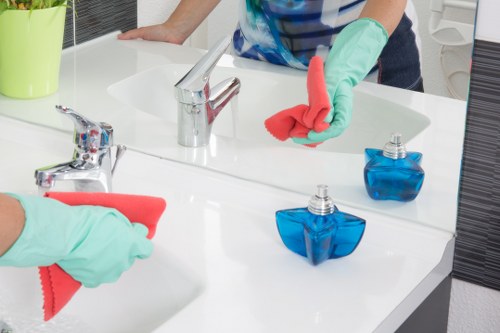 Office cleaning team in Fulham sanitising shared workspace surfaces